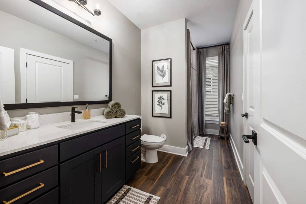 Bathroom with painted vanity and gold hardware