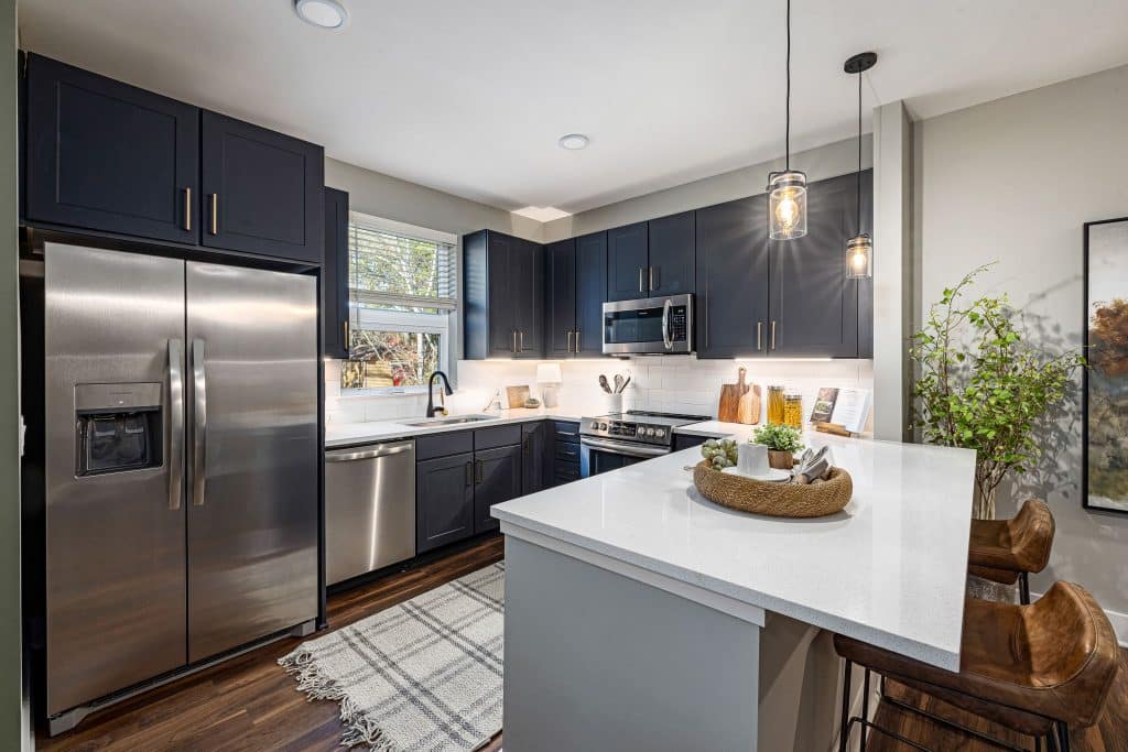 kitchen with granite and stainless steel like appliances and side by side refrigerator